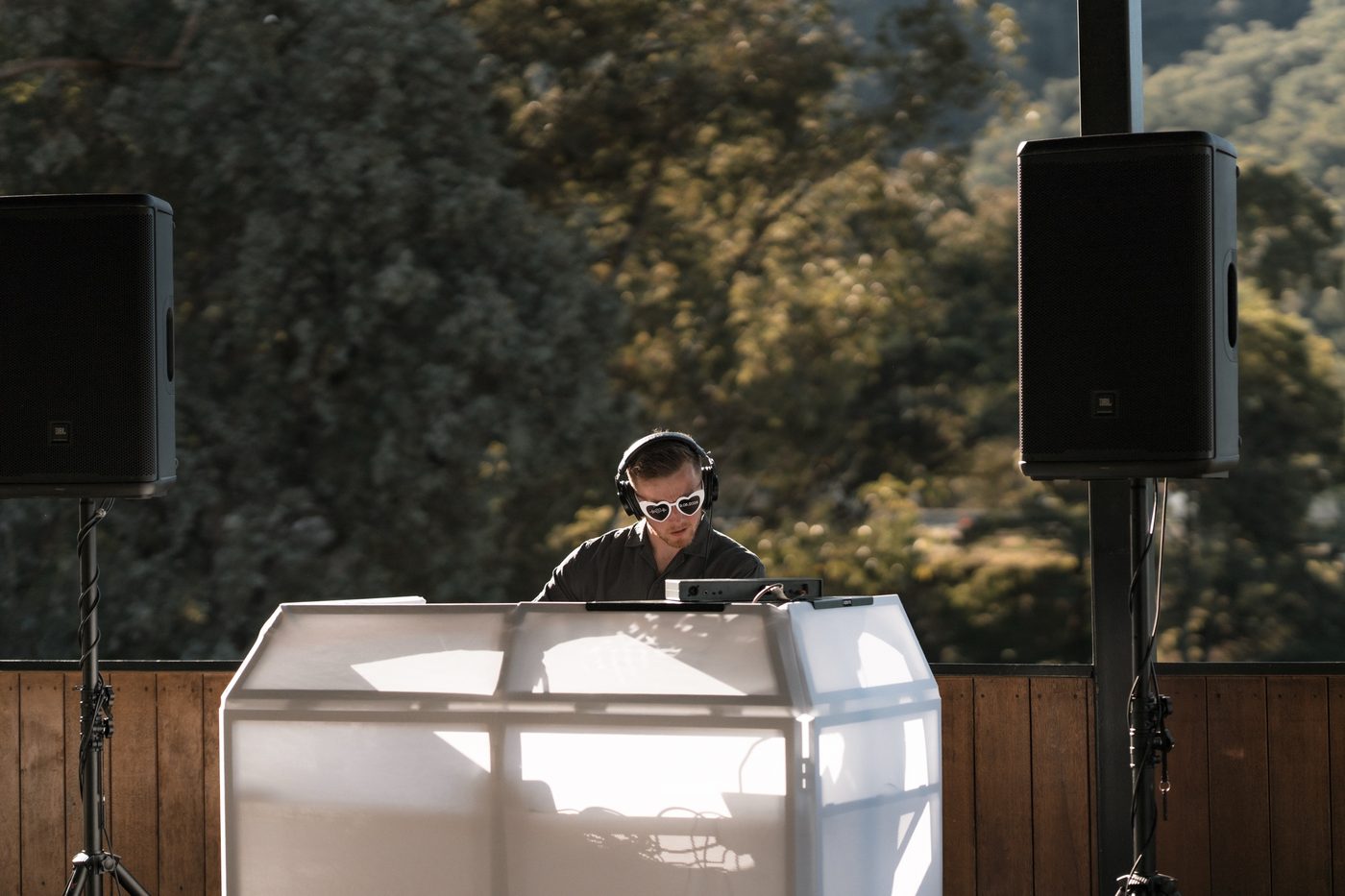 Tom DJing an outdoor event in heart-shaped sunglasses